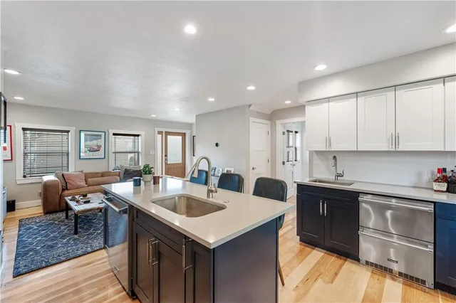 a kitchen with granite countertop a sink and cabinets