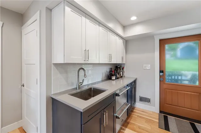 a kitchen with a sink cabinets and window