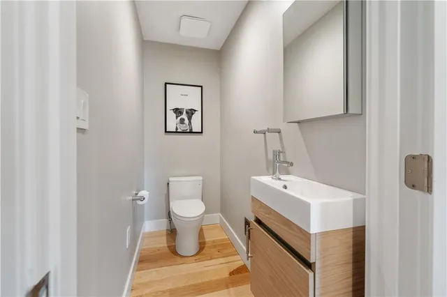 a bathroom with a sink toilet and mirror