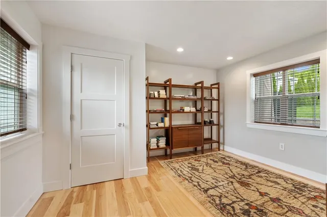 a view of a livingroom with wooden floor and a window