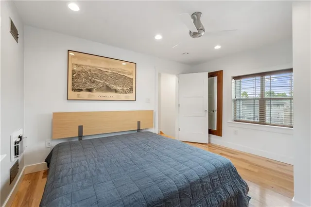 a bedroom with a bed and a painting on the wall