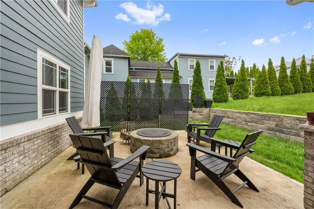 a view of a patio with table and chairs and potted plants with wooden floor and fence