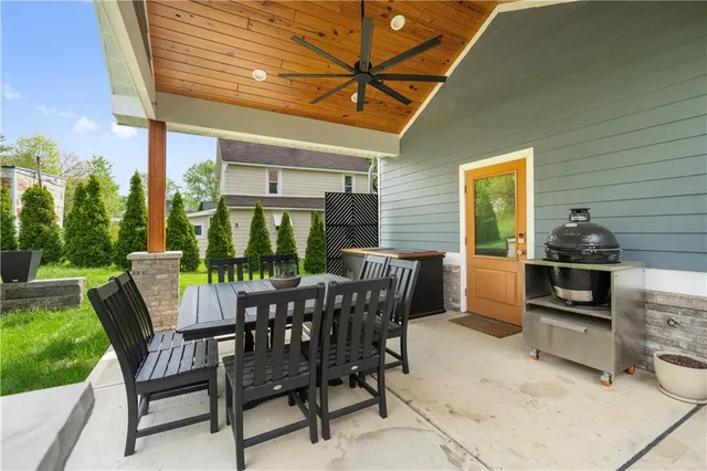 a view of a patio with a dining table and chairs