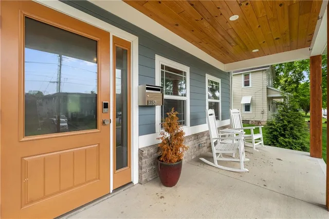a view of a patio with table and chairs and potted plants