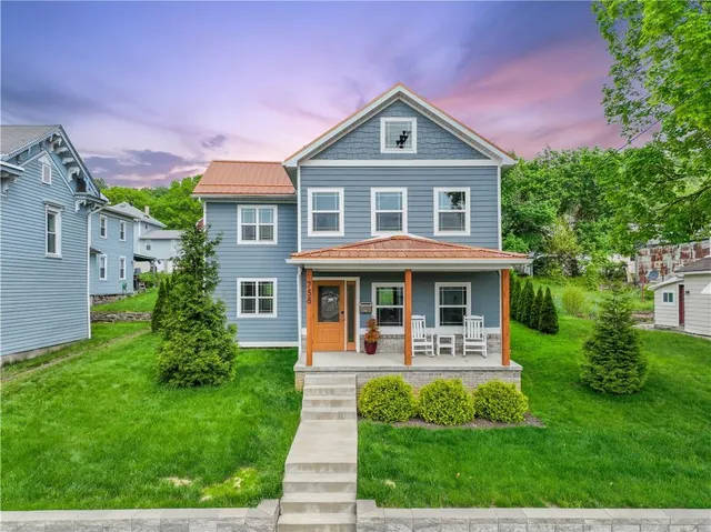 a front view of a house with garden