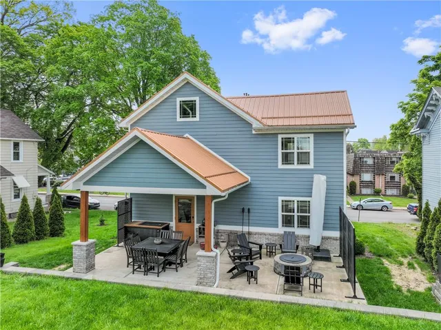 a view of a house with backyard sitting area and garden