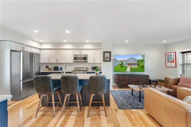 a view of a dining room with furniture a rug and wooden floor