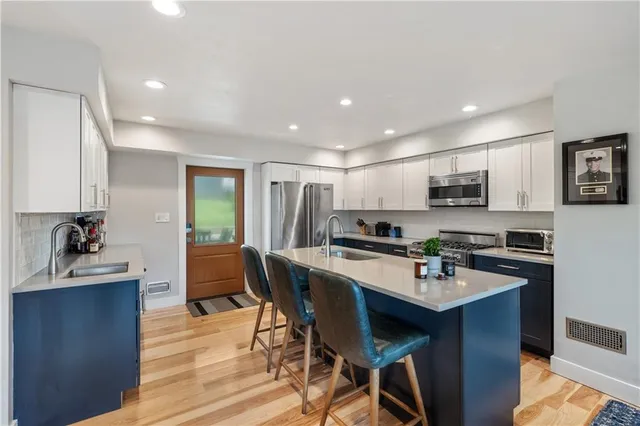 a kitchen with a dining table chairs and microwave