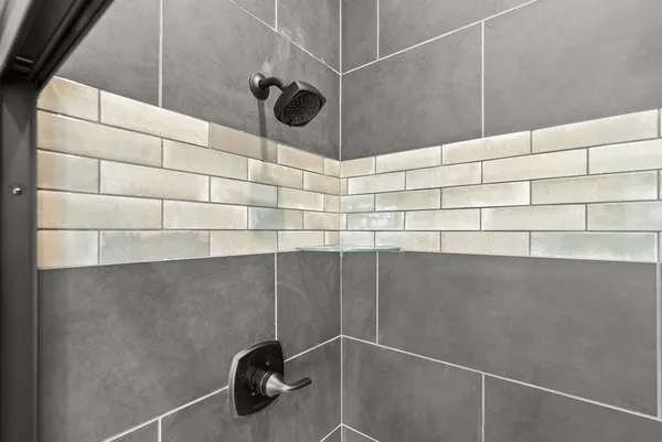 a bathroom with a granite countertop sink a toilet and shower