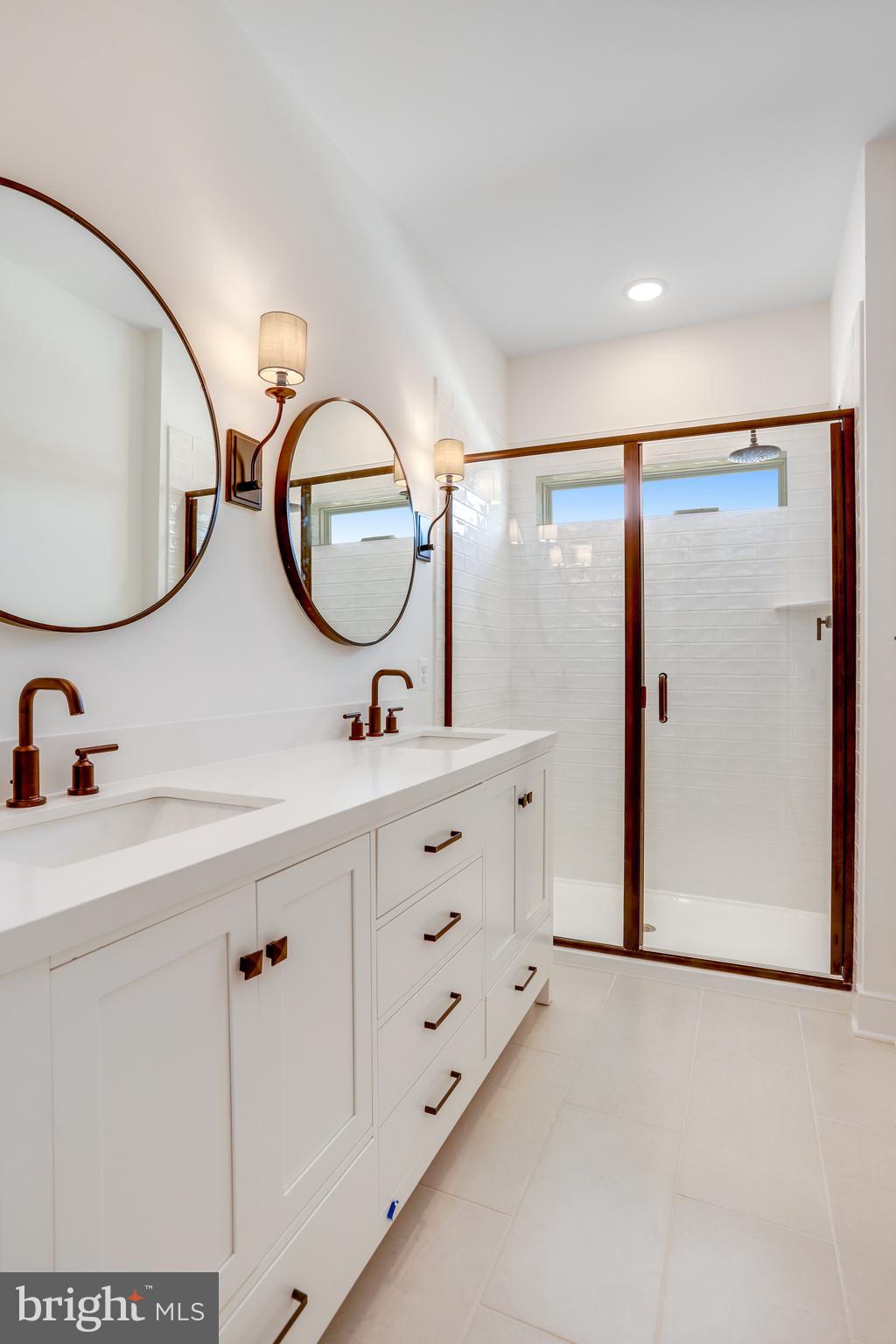 755 Elevation Road Frederick, MD 21702 - Photo 23 of 35 a bathroom with a sink mirror and a shower