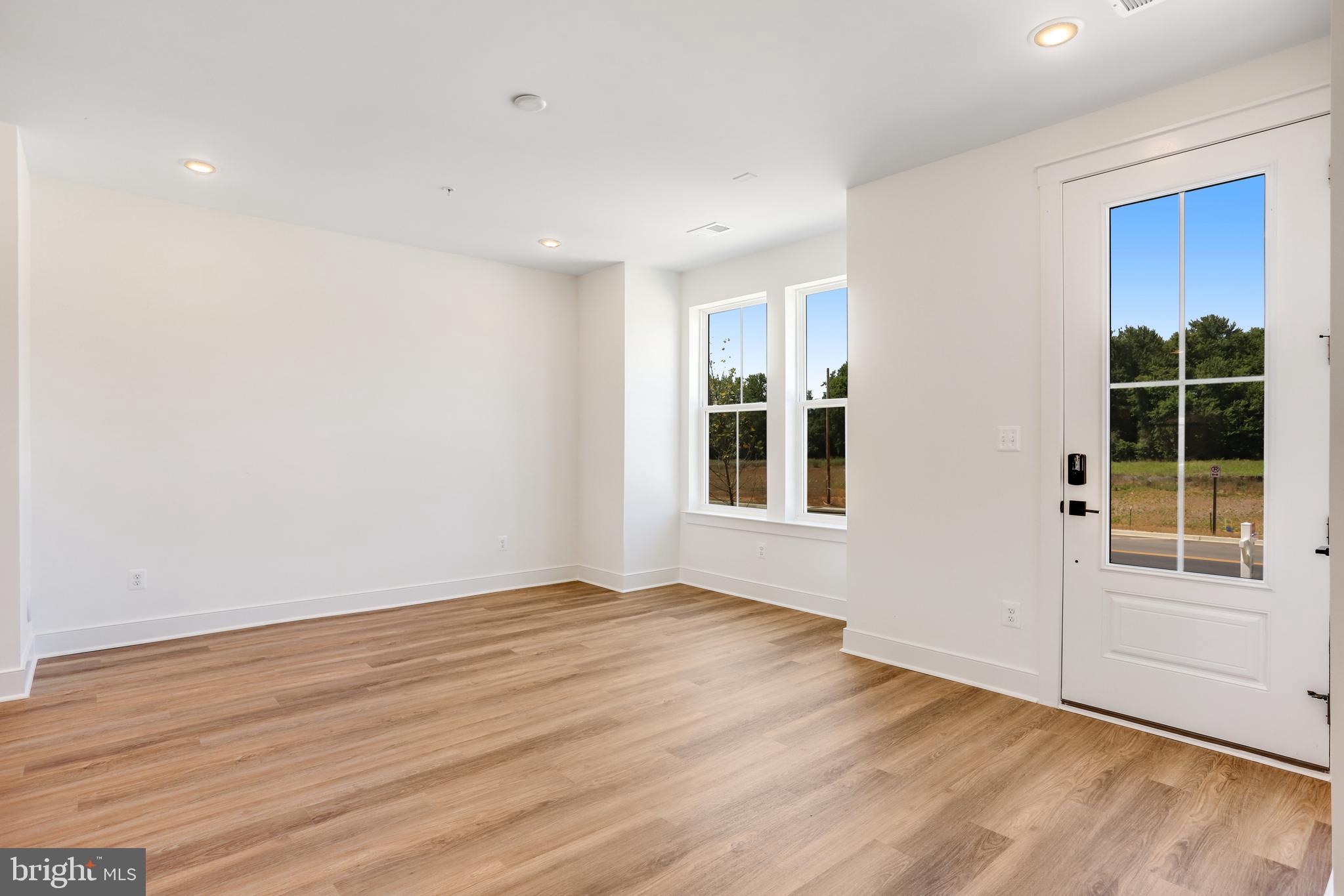 755 Elevation Road Frederick, MD 21702 - Photo 3 of 35 an empty room with wooden floor and windows