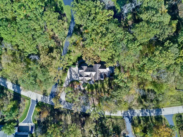 an aerial view of a house with a yard