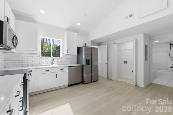 a large bathroom with a granite countertop sink mirror and shower