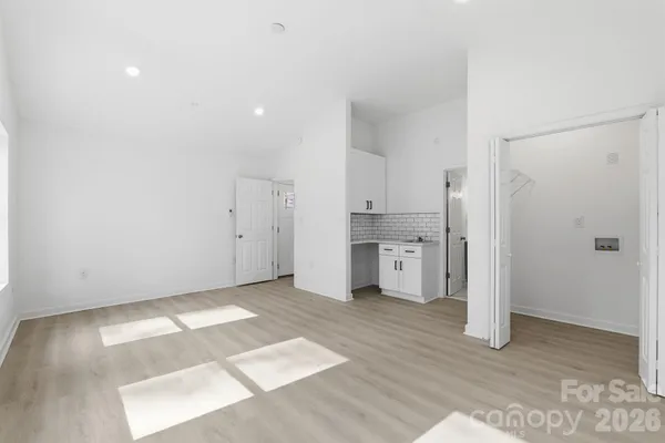 a view of a kitchen with a sink and a refrigerator