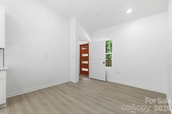 an empty room with closet and wooden floor