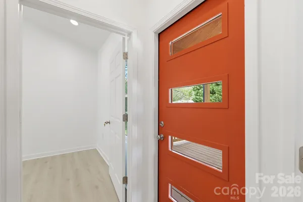 a view of a hallway with wooden floor