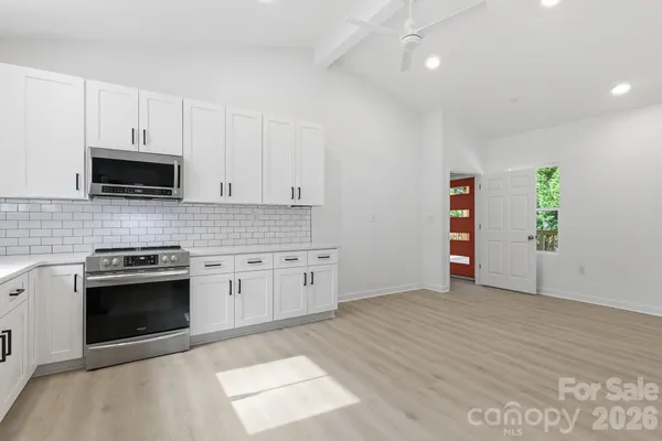 a kitchen with stainless steel appliances granite countertop a stove and a sink