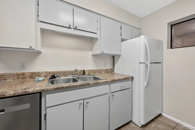 a kitchen with stainless steel appliances granite countertop a refrigerator sink and cabinets