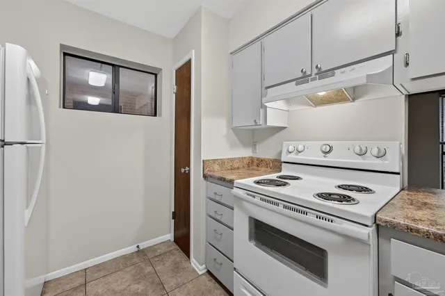 a kitchen with a stove and a refrigerator