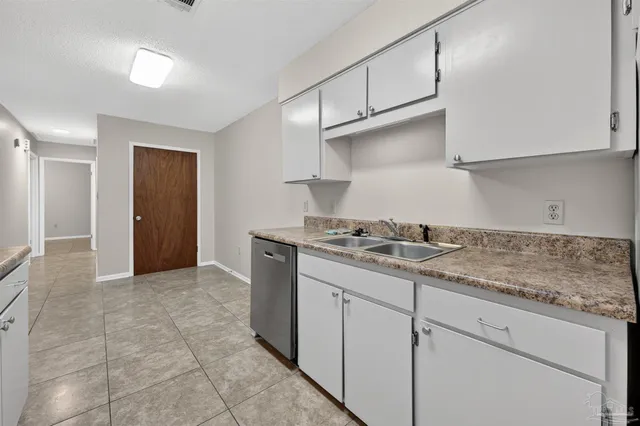 a kitchen with granite countertop a sink and a stove