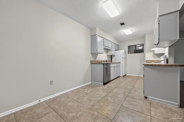 a kitchen with stainless steel appliances granite countertop a refrigerator sink and cabinets
