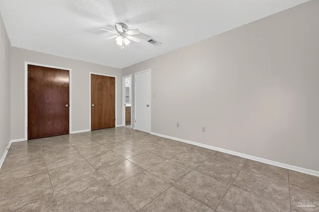 a view of an empty room with a ceiling fan