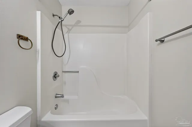 a bathroom with a sink toilet vanity and shower