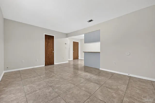 a view of an empty room with a fireplace