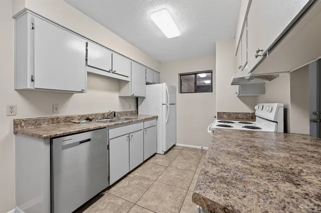a kitchen with stainless steel appliances granite countertop a stove and a sink