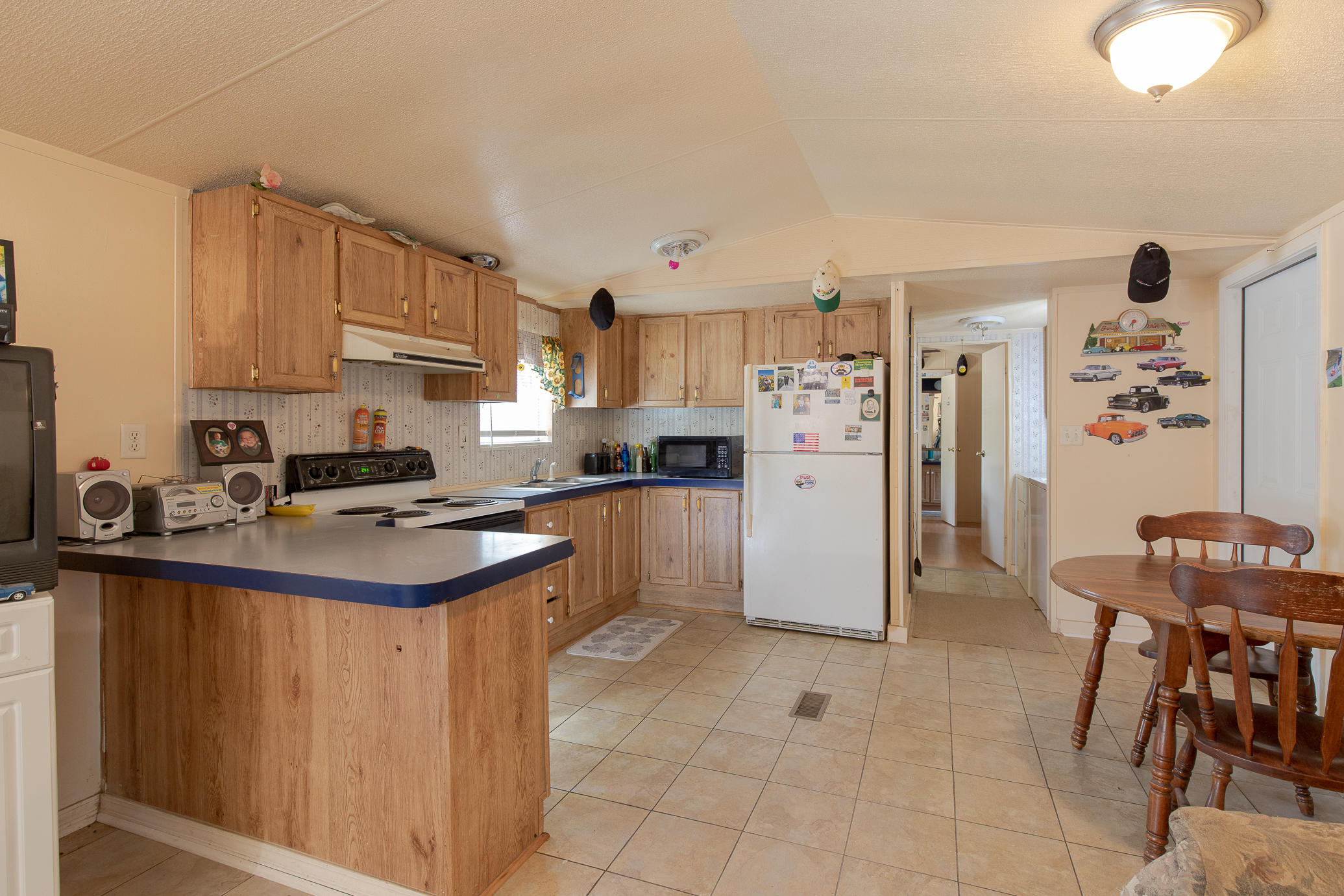 973 Valley Road Crestview, FL 32539 - Photo 4 of 20 a kitchen with a sink a refrigerator and a stove