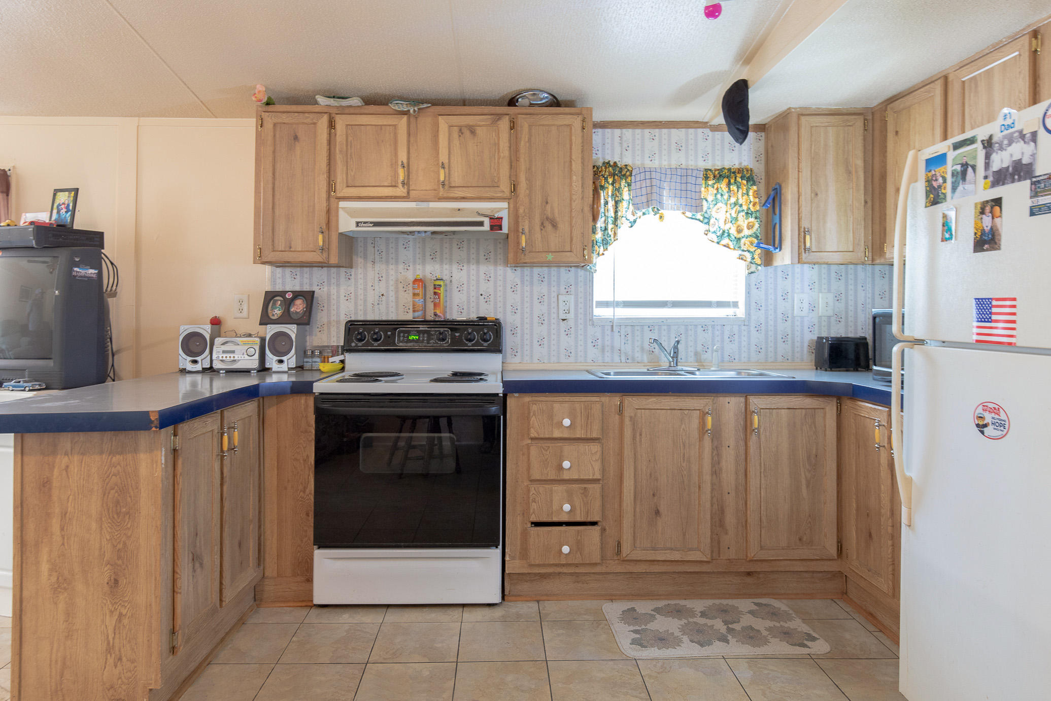 973 Valley Road Crestview, FL 32539 - Photo 5 of 20 a kitchen with stainless steel appliances granite countertop a stove a sink and a refrigerator