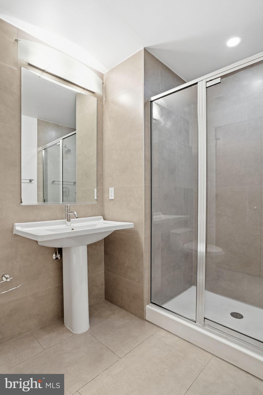 1133 14th Street Northwest, Unit 505 Washington, DC 20005 - Photo 13 of 17 a bathroom with a sink and mirror