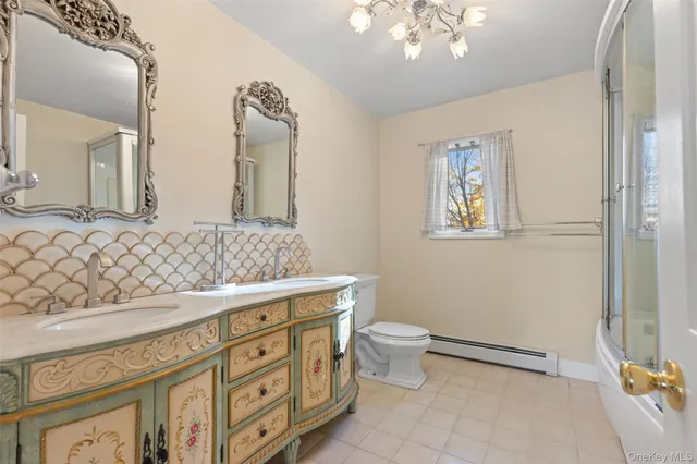 a bathroom with a toilet a sink and mirror