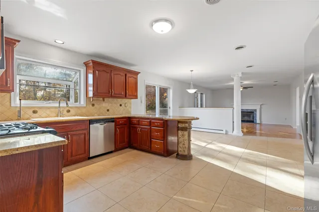 a large kitchen with stainless steel appliances and a stove