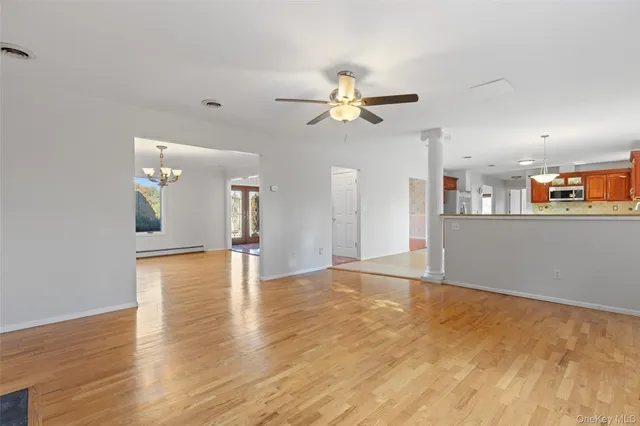 a view of a kitchen with an empty space and a ceiling fan