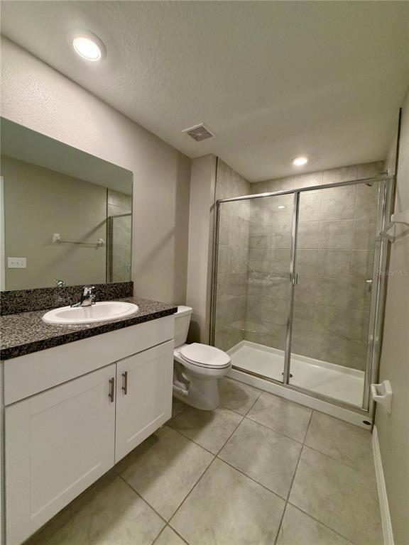 11826 Dumaine Valley Road Riverview, FL 33579 - Photo 26 of 54 a bathroom with a granite countertop sink a toilet and a mirror