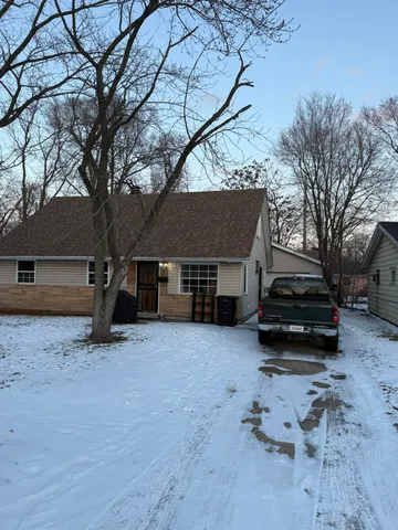 a view of a house with a yard covered in snow