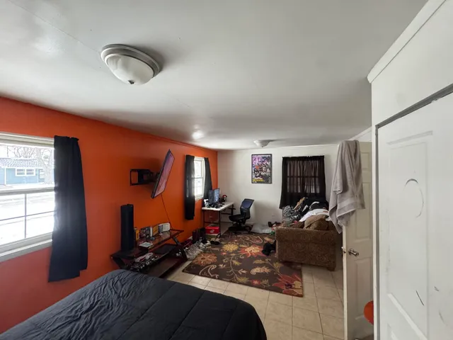 a living room with furniture a window and gym equipment