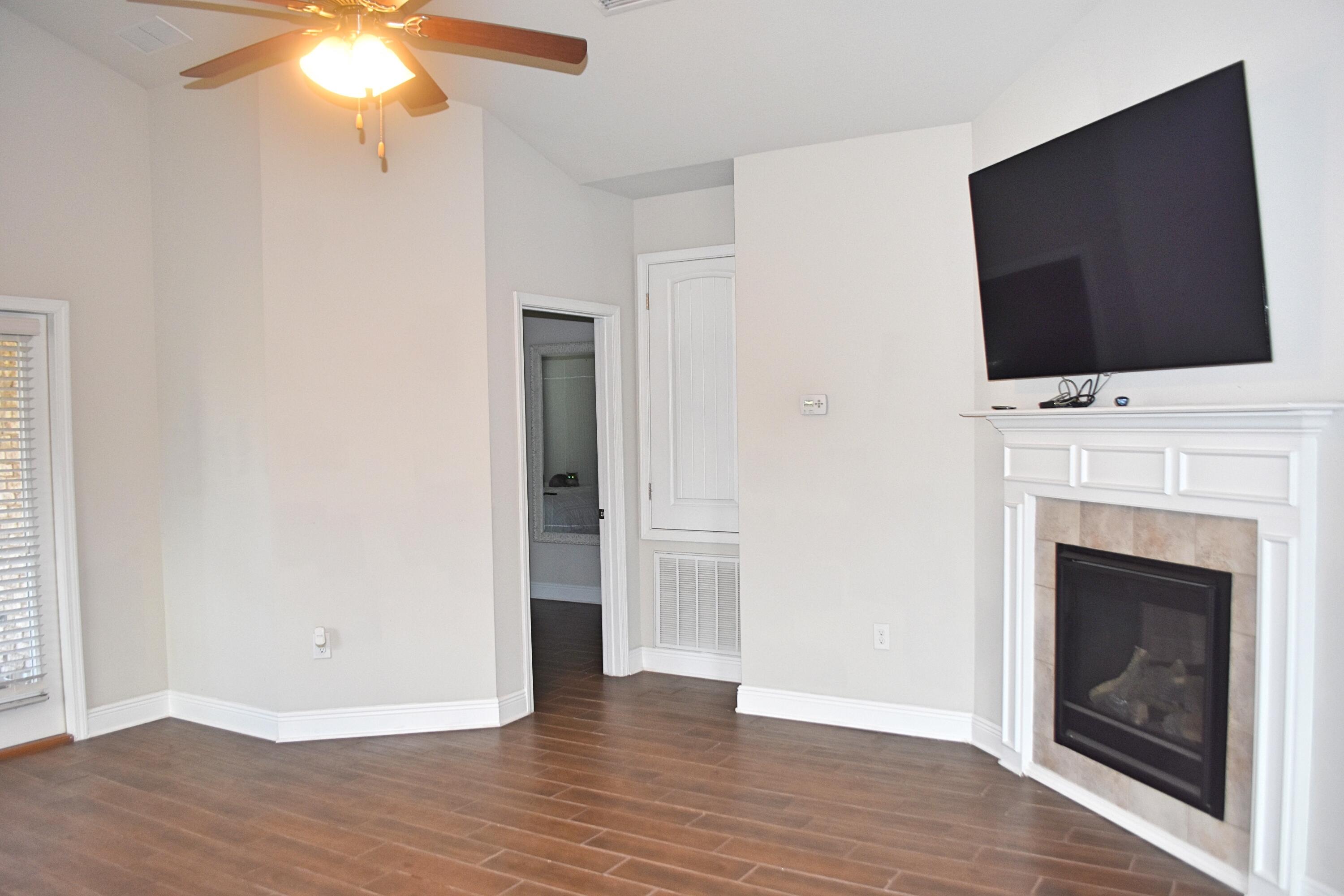 41 Twain Trail Freeport, FL 32439 - Photo 11 of 24 a view of an empty room with wooden floor fireplace and a window
