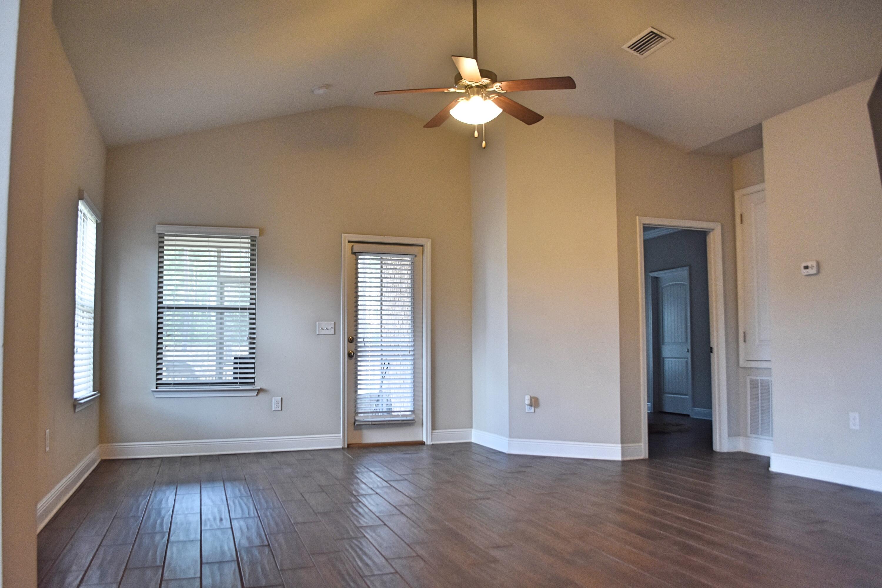 41 Twain Trail Freeport, FL 32439 - Photo 12 of 24 an empty room with wooden floor chandelier and glass door