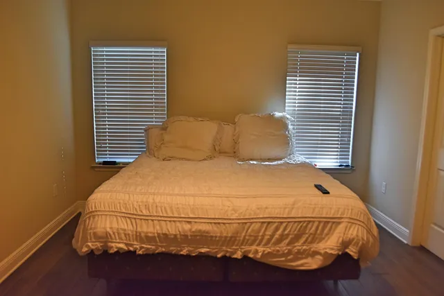 a bedroom with a bed and a window