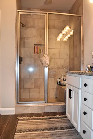 a bathroom with a mirror and a shower