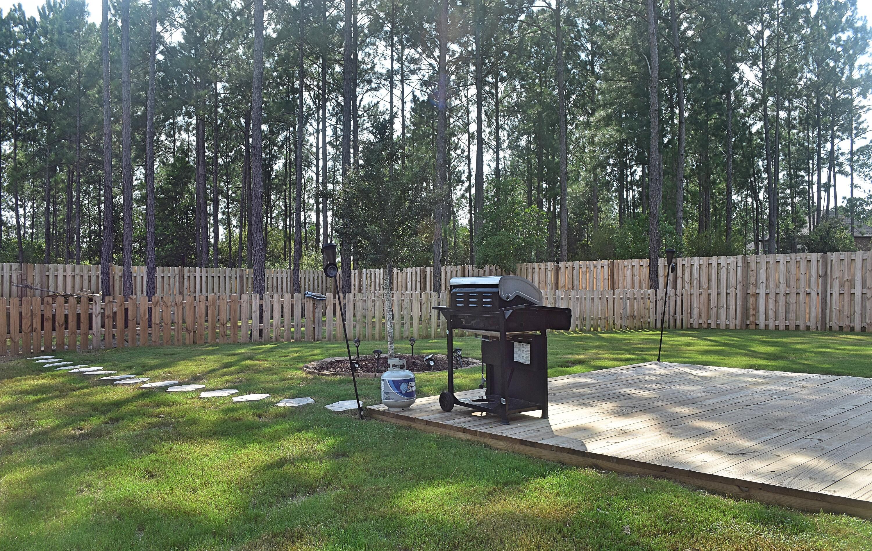 41 Twain Trail Freeport, FL 32439 - Photo 2 of 24 a view of a backyard with wooden fence and a bench