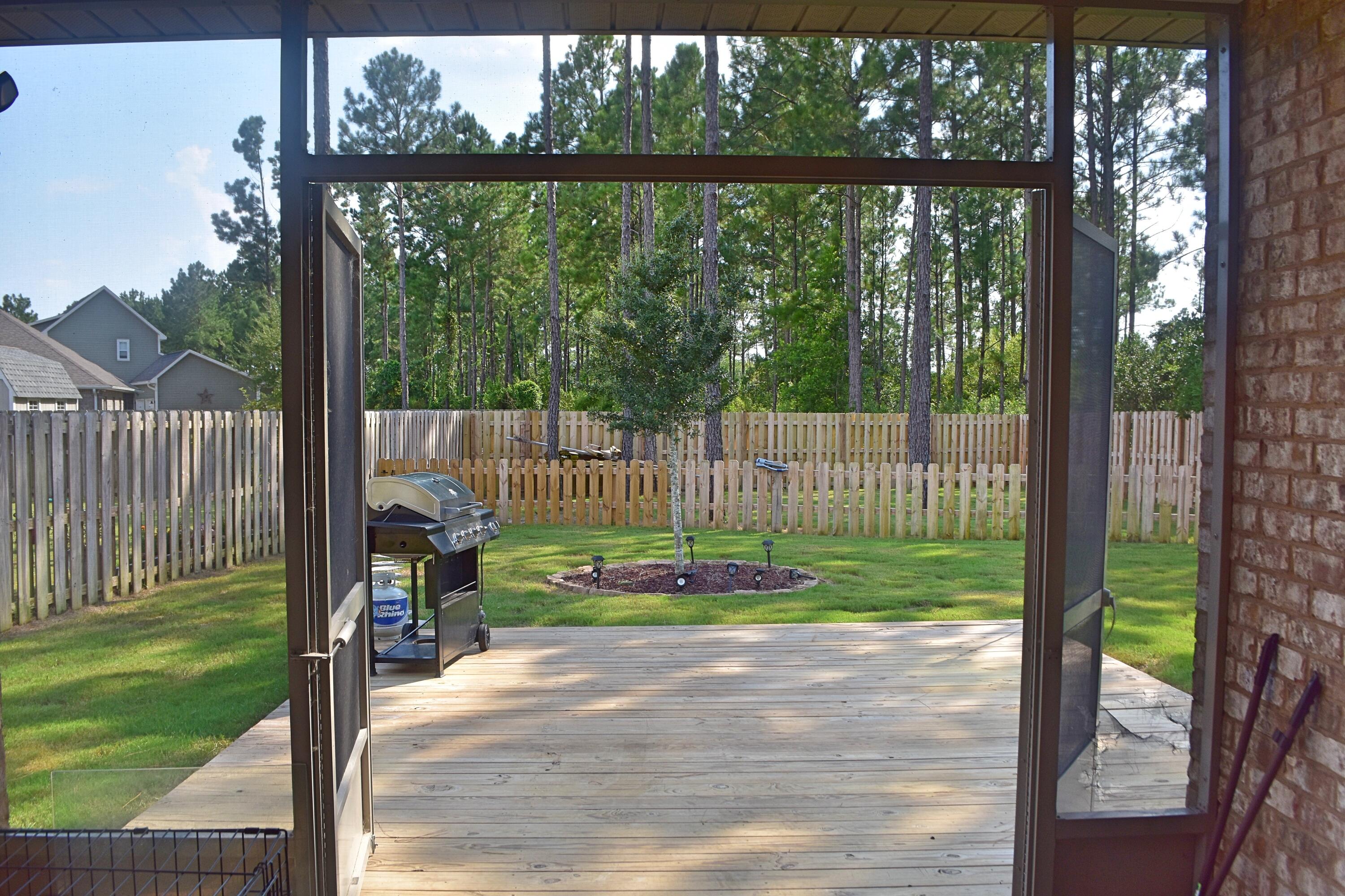 41 Twain Trail Freeport, FL 32439 - Photo 5 of 24 a view of a park with a large trees and wooden fence