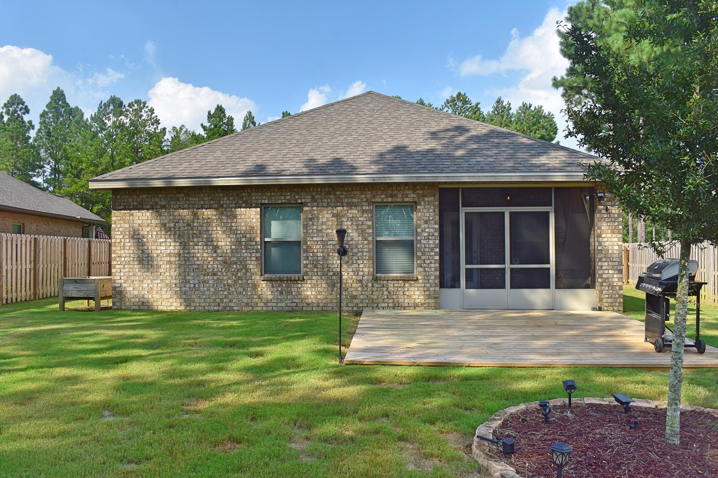 41 Twain Trail Freeport, FL 32439 - Photo 6 of 24 a front view of a house with a garden