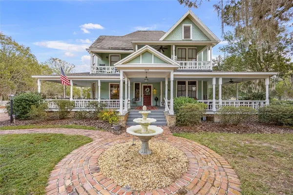 a front view of a house with yard and porch
