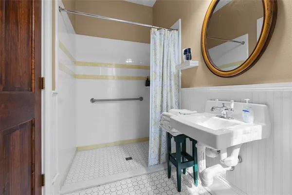 a bathroom with a sink toilet and shower