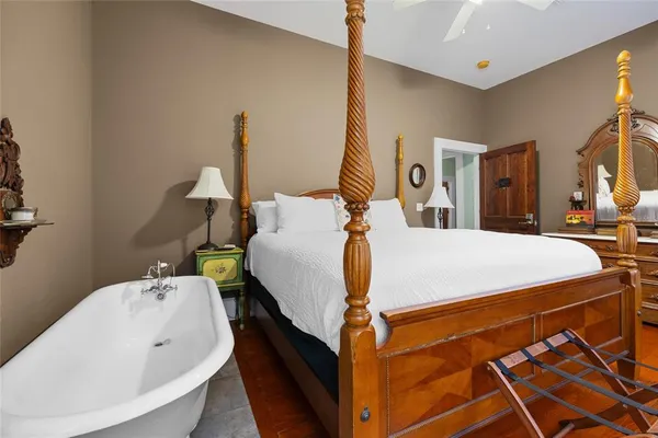 a bedroom with a bed and wooden floor