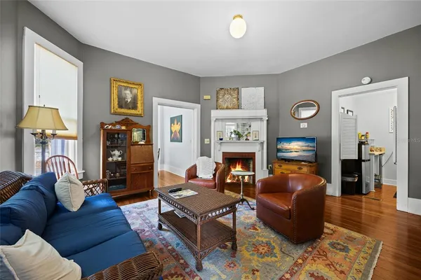 a kitchen with stainless steel appliances kitchen island granite countertop a dining table chairs microwave and sink