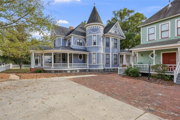 an aerial view of a house with garden space and street view